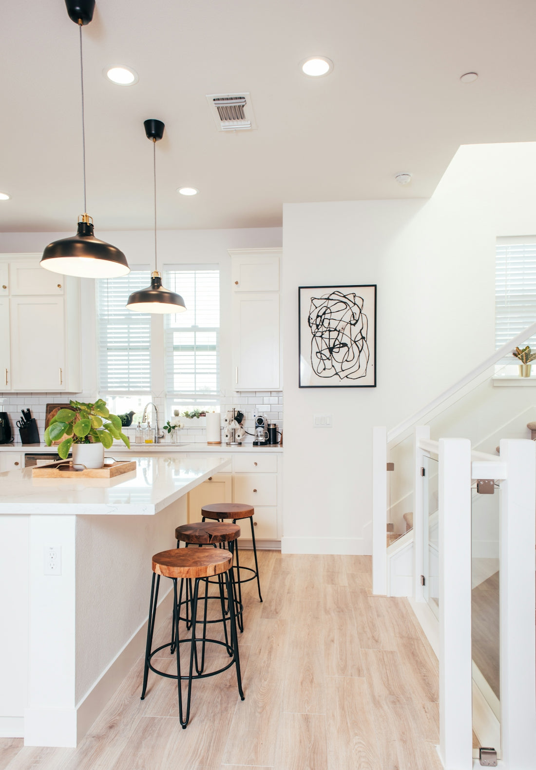A kitchen with a wooden floor and white walls